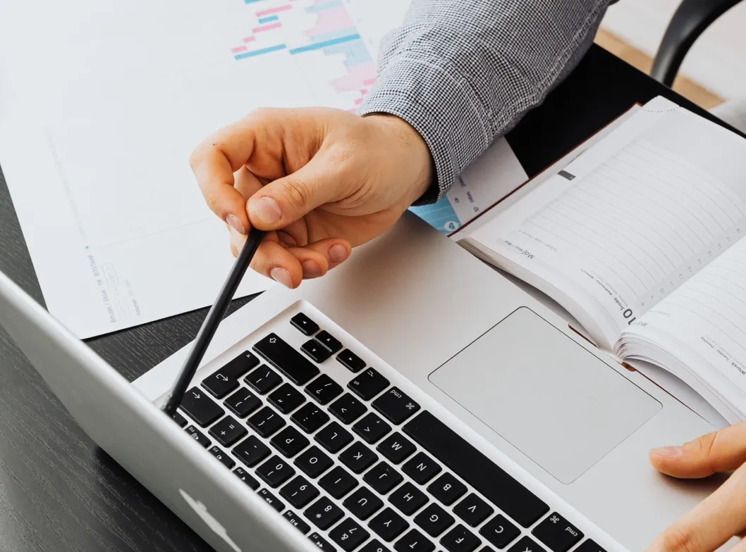 A finance team member reviewing a report on a laptop